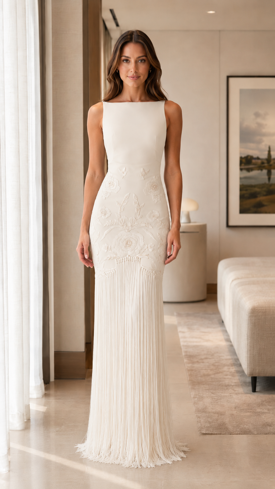 Front view of ivory sleeveless embroidered fringe gown