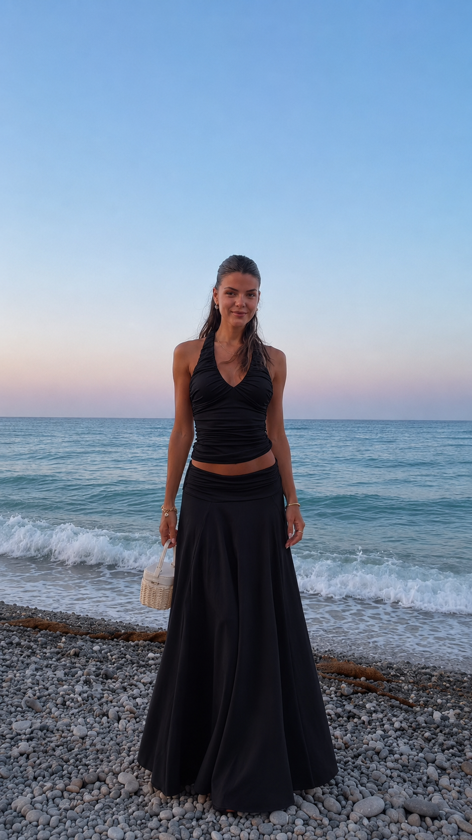 Front view of black ruched halter top and maxi skirt two-piece set