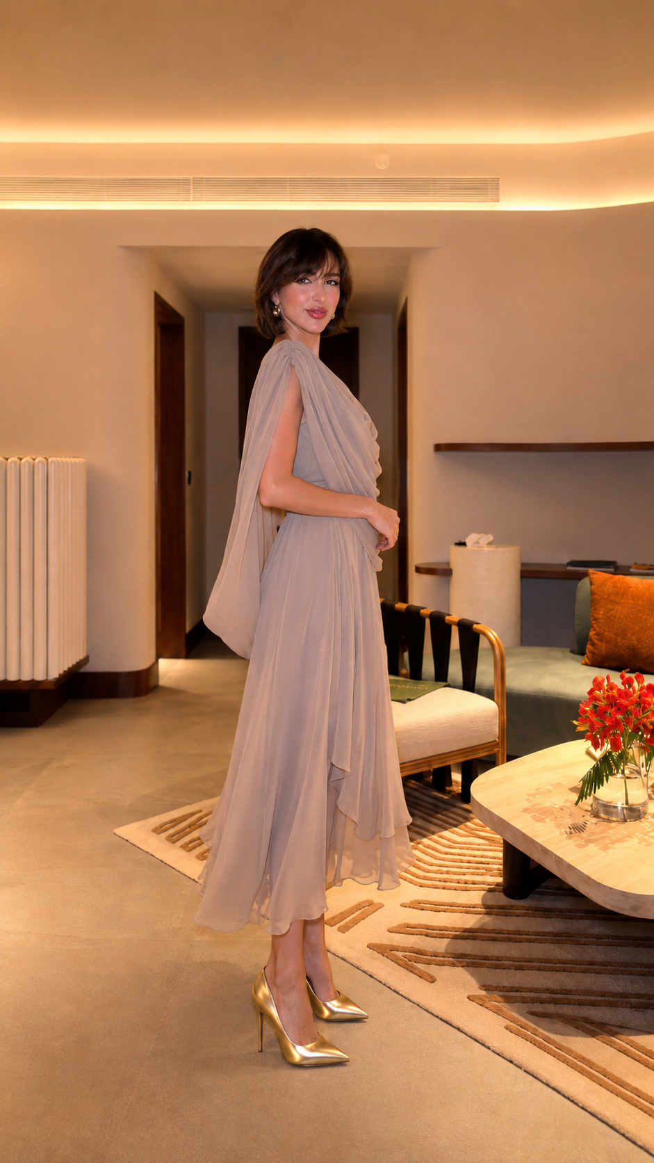 Side view of taupe midi dress showing soft drape and asymmetric layered skirt