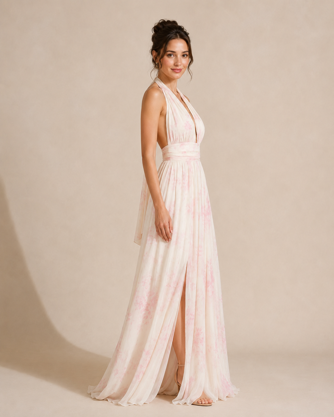 Side view of blush floral halter maxi dress showing open side and fluid drape